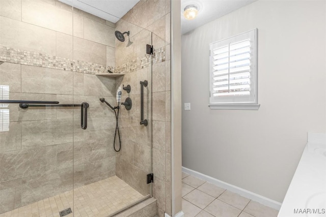 bathroom featuring tile patterned floors and a shower with shower door