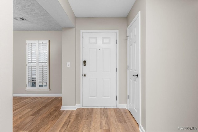 foyer entrance with wood-type flooring