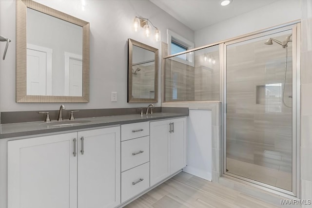 bathroom featuring vanity and a shower with shower door