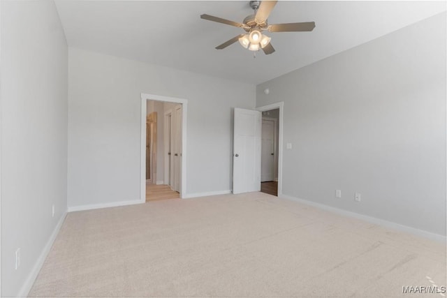 unfurnished bedroom with ceiling fan, connected bathroom, and light carpet