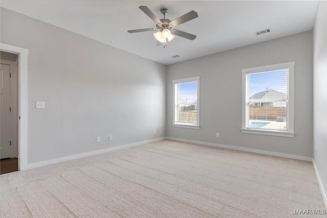 spare room featuring ceiling fan and light colored carpet