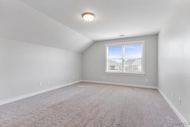 additional living space with lofted ceiling and carpet