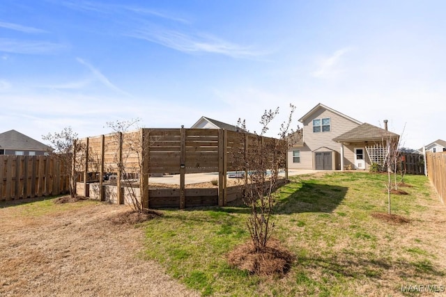 back of property with a yard and a shed