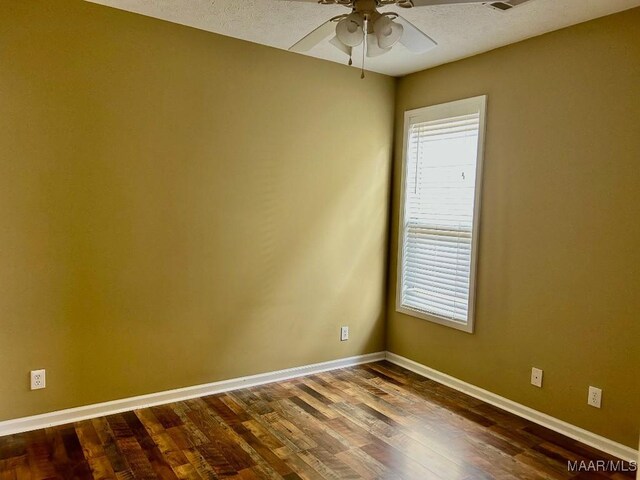 empty room featuring hardwood / wood-style floors and ceiling fan