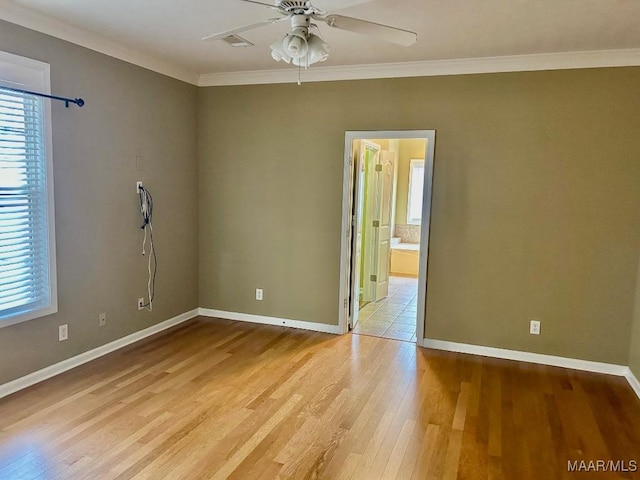 spare room featuring crown molding, ceiling fan, and light wood-type flooring