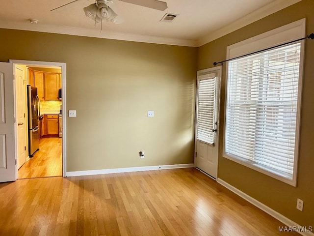 unfurnished room with crown molding, ceiling fan, and light wood-type flooring