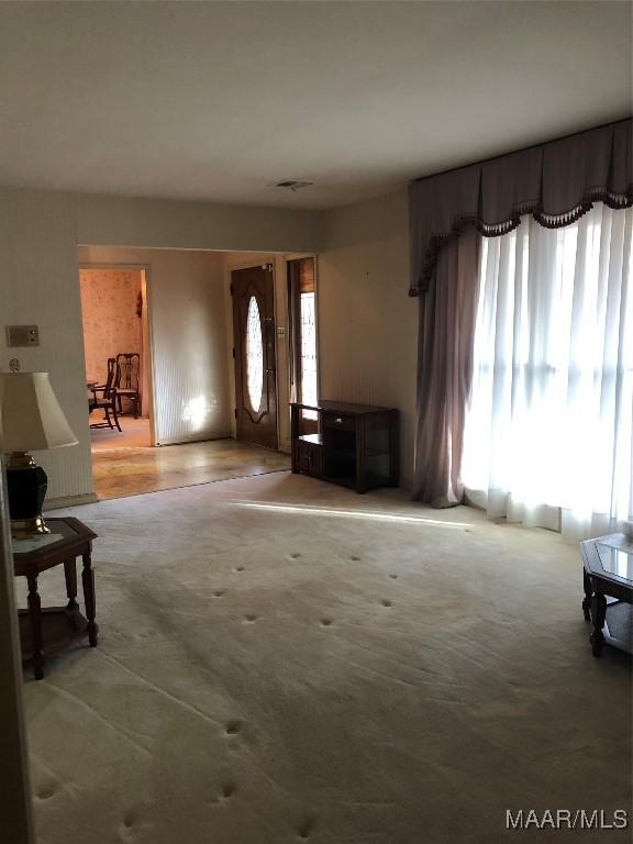 view of carpeted entrance foyer