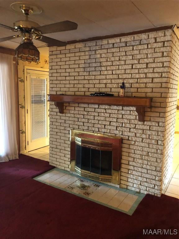 interior details with ceiling fan, a fireplace, and carpet floors