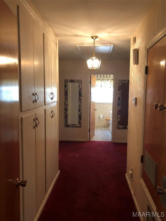 hallway featuring dark carpet