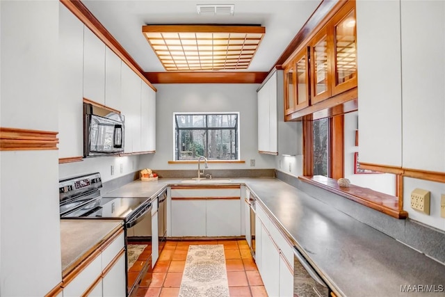 120 Willow Ln, Wetumpka, AL 36092 - kitchen with black appliances, a sink, white cabinets, light tile patterned floors, and light countertops