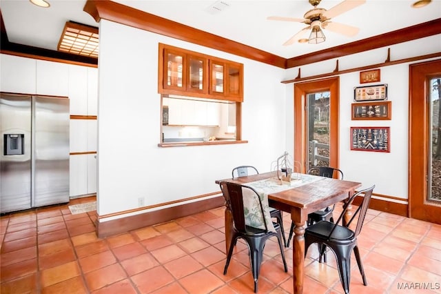 tiled dining space featuring ceiling fan