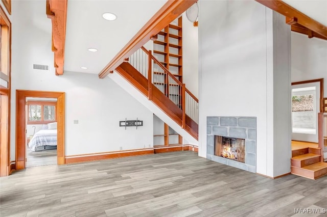 120 Willow Ln, Wetumpka, AL 36092 - unfurnished living room with stairs, wood finished floors, recessed lighting, plenty of natural light, and a towering ceiling