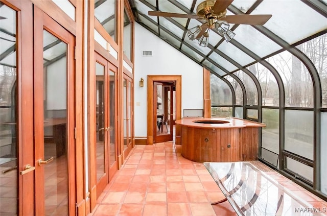 unfurnished sunroom featuring vaulted ceiling and ceiling fan