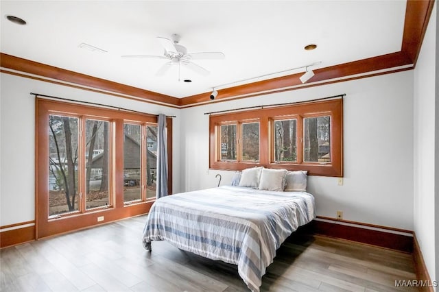 bedroom featuring ornamental molding and light hardwood / wood-style flooring