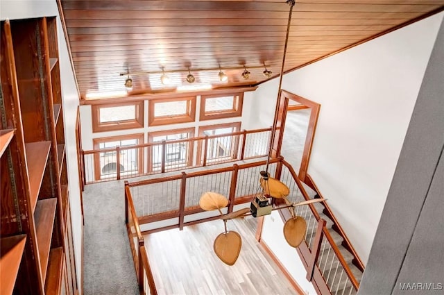 interior space with wooden ceiling and rail lighting