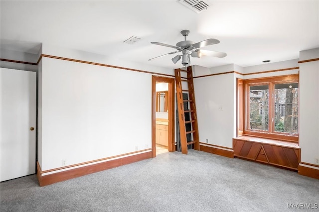 empty room with ceiling fan and carpet floors