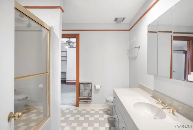 bathroom featuring ceiling fan, vanity, and toilet