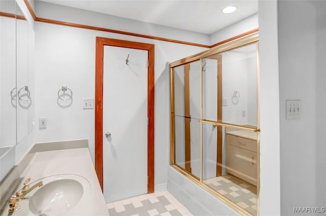 bathroom with vanity and combined bath / shower with glass door