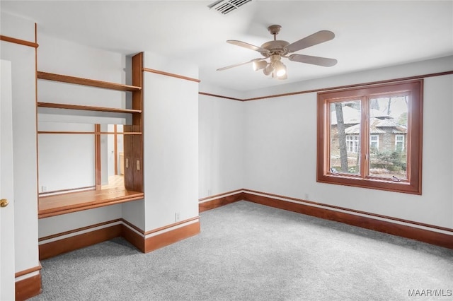 carpeted spare room with ceiling fan