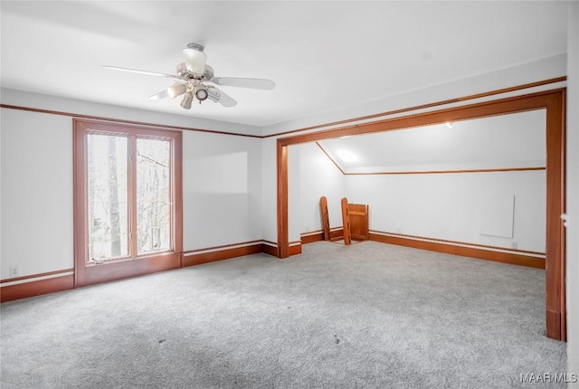 bonus room with light carpet and ceiling fan