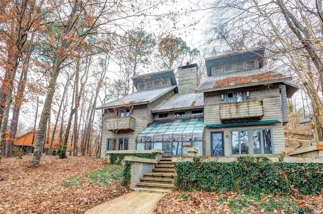 120 Willow Ln, Wetumpka, AL 36092 - view of front of home with metal roof, a chimney, and stairs
