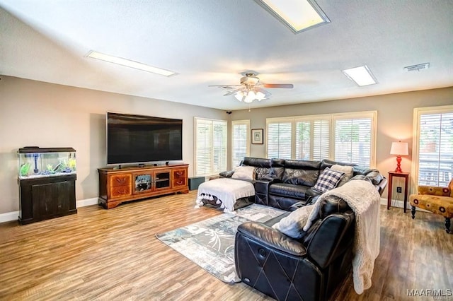 living room with ceiling fan and light wood-type flooring