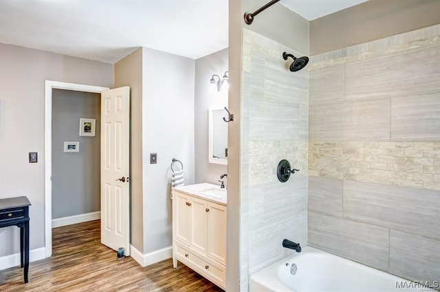 bathroom with vanity, tiled shower / bath combo, and hardwood / wood-style flooring