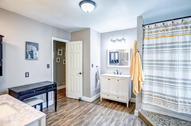 bathroom featuring vanity, wood-type flooring, and shower / bath combination with curtain