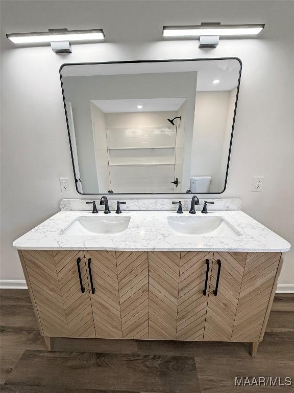 bathroom with vanity, hardwood / wood-style flooring, and toilet