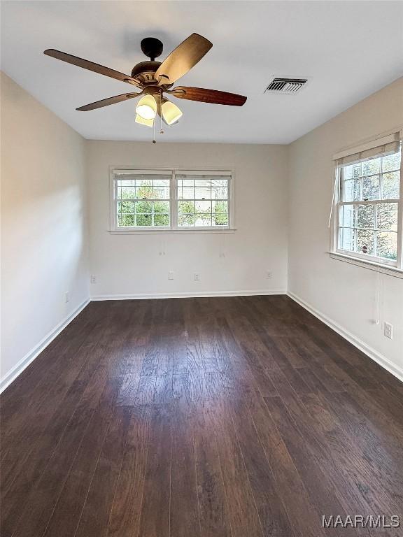 spare room with dark hardwood / wood-style floors and ceiling fan