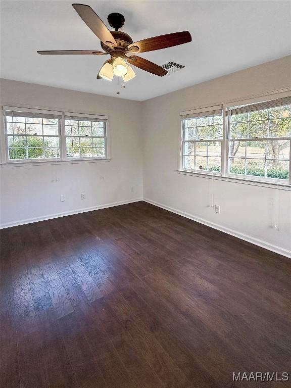 empty room featuring dark hardwood / wood-style floors and ceiling fan