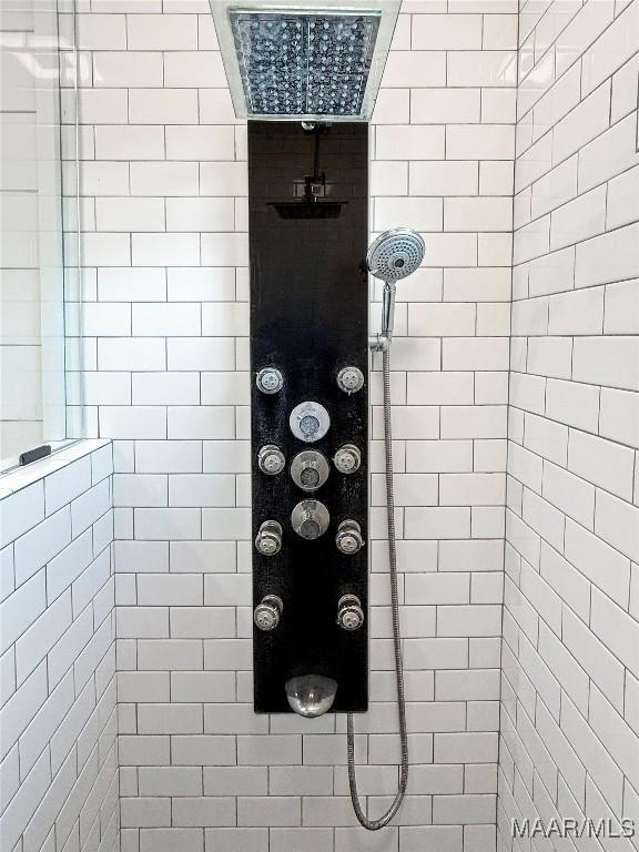 bathroom with a tile shower