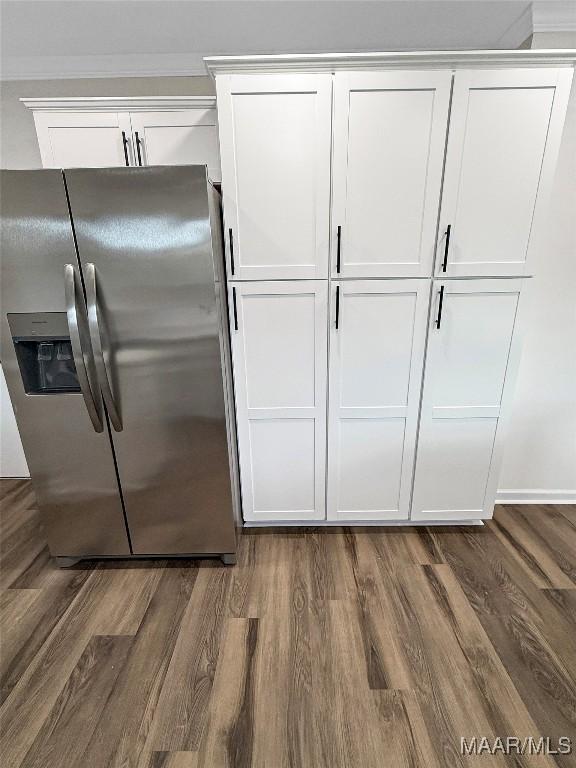 interior space featuring white cabinetry, dark wood-type flooring, and stainless steel refrigerator with ice dispenser