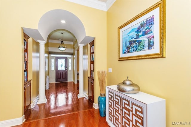 entryway featuring ornate columns, ornamental molding, and dark hardwood / wood-style floors