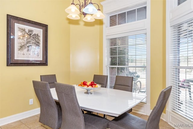 dining area with a notable chandelier and light tile patterned floors