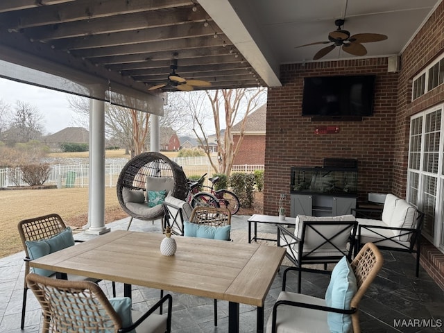 view of patio with a water view, outdoor lounge area, and ceiling fan