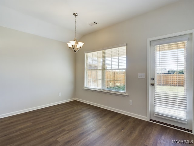 interior space with dark hardwood / wood-style flooring, a wealth of natural light, and a chandelier