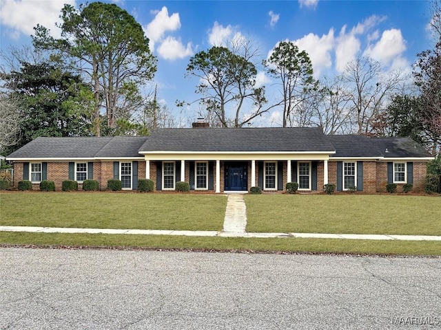 single story home with covered porch, a front lawn, and brick siding