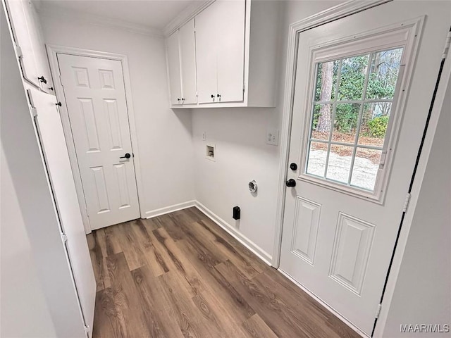 clothes washing area with washer hookup, crown molding, dark wood finished floors, cabinet space, and baseboards