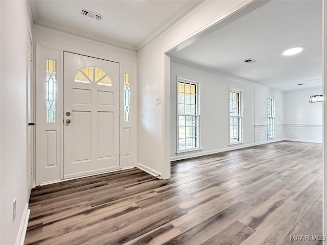 entrance foyer with crown molding and hardwood / wood-style flooring