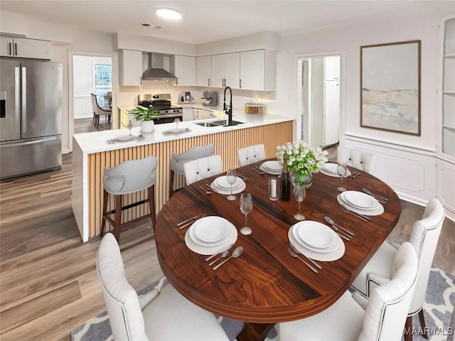 dining area featuring visible vents and light wood finished floors