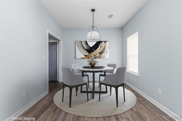 dining area featuring dark wood-type flooring