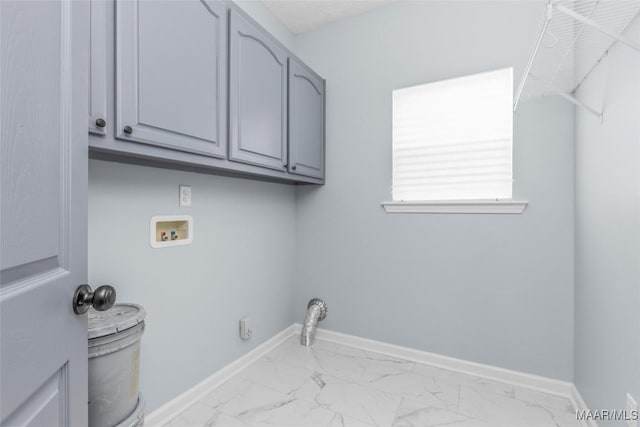 clothes washing area with baseboards, marble finish floor, cabinet space, and hookup for a washing machine