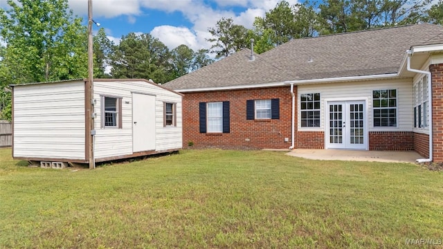 541 Baltzer Rd, Wetumpka, AL 36092 - back of property with brick siding, french doors, a patio, roof with shingles, and a lawn