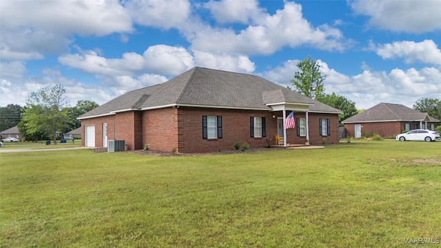 541 Baltzer Rd, Wetumpka, AL 36092 - view of front of house featuring a garage, a front yard, brick siding, a shingled roof, and central air condition unit