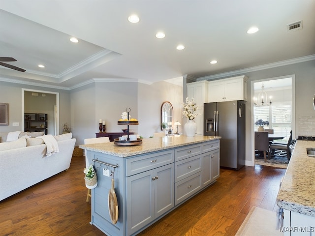 kitchen with ceiling fan with notable chandelier, gray cabinetry, a center island, stainless steel refrigerator with ice dispenser, and dark wood-type flooring