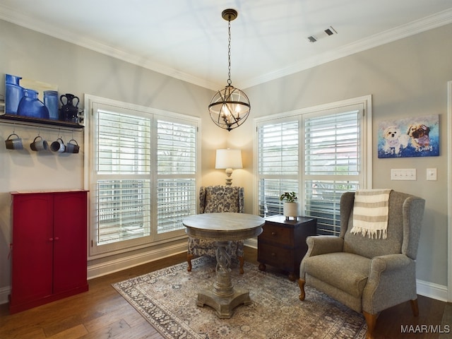 sitting room featuring ornamental molding, a chandelier, and dark hardwood / wood-style flooring