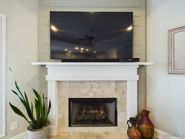 interior details with ceiling fan and a fireplace