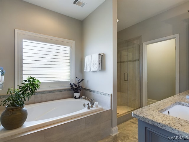 bathroom with vanity and separate shower and tub