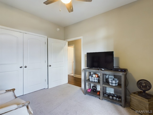 living area featuring ceiling fan and carpet